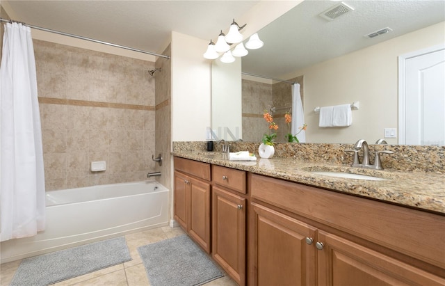 bathroom with tile floors, dual bowl vanity, a textured ceiling, and shower / bath combo with shower curtain