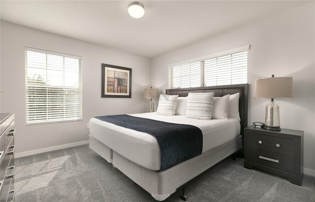 carpeted bedroom with baseboards and multiple windows