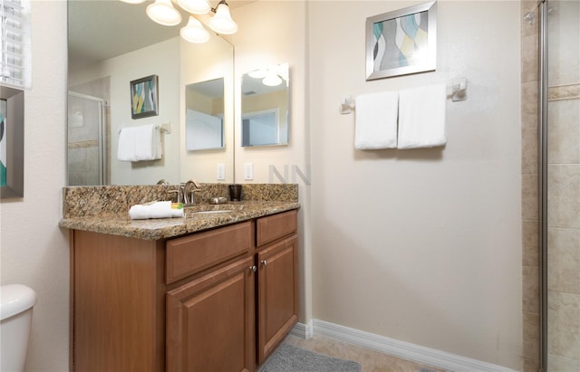 bathroom featuring walk in shower, oversized vanity, toilet, and tile floors