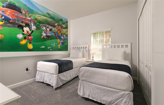 bedroom featuring a closet and dark carpet