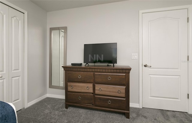 bedroom featuring baseboards and dark carpet