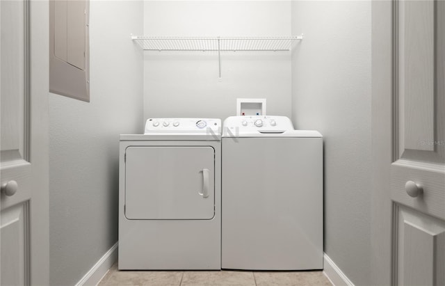 clothes washing area featuring washer and dryer, electric panel, tile patterned flooring, and baseboards