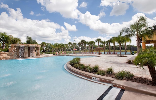 view of swimming pool with pool water feature