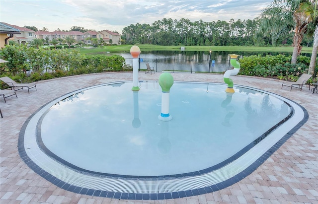 surrounding community with fence and a water view