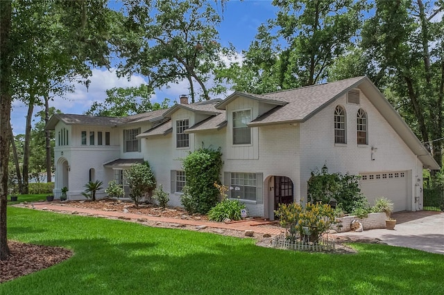 view of front of home featuring a garage and a front lawn