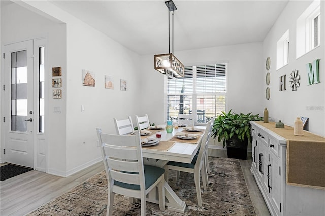 dining area featuring baseboards and wood finished floors