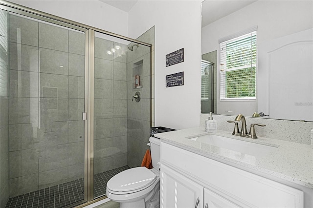 full bathroom with toilet, a shower stall, and vanity