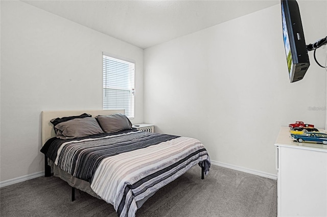 bedroom with baseboards and carpet flooring