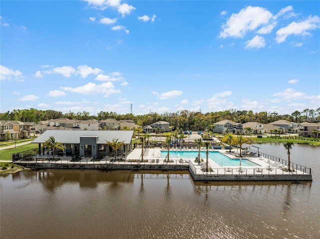 dock area with a water view, a patio area, a community pool, and a residential view