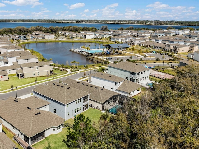 drone / aerial view featuring a water view and a residential view