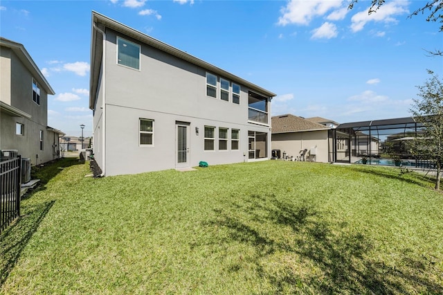 back of house featuring a fenced in pool, glass enclosure, cooling unit, a yard, and stucco siding