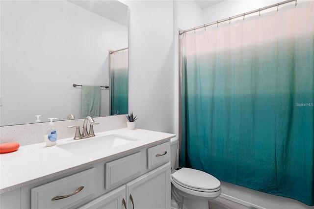 bathroom with toilet, curtained shower, and vanity