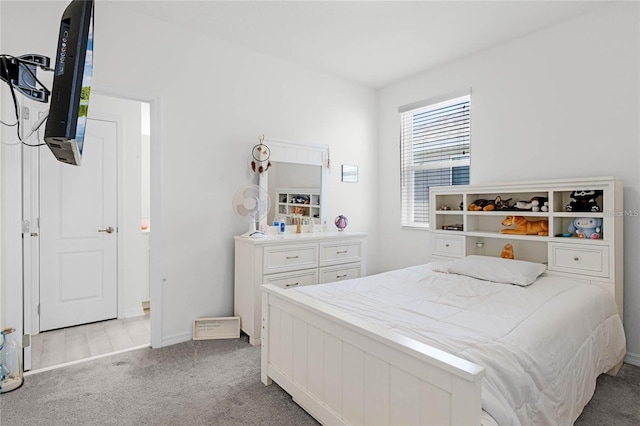 carpeted bedroom featuring baseboards