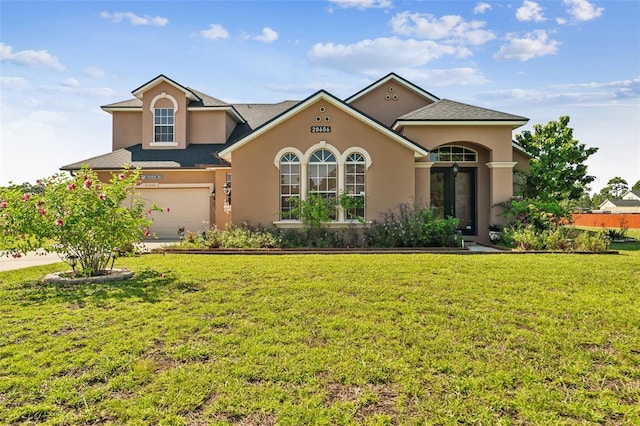 view of front facade with a garage and a front lawn