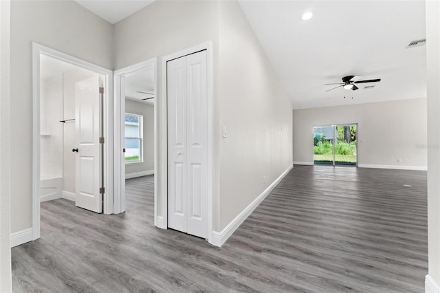 corridor with hardwood / wood-style floors