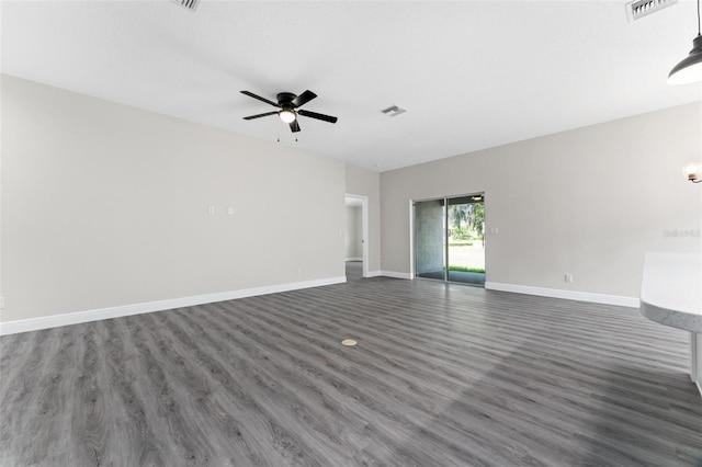 unfurnished living room with ceiling fan and dark hardwood / wood-style floors