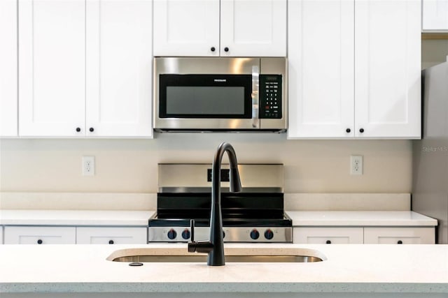 kitchen with white cabinets and stove