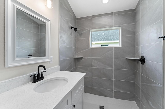 bathroom with vanity and tiled shower