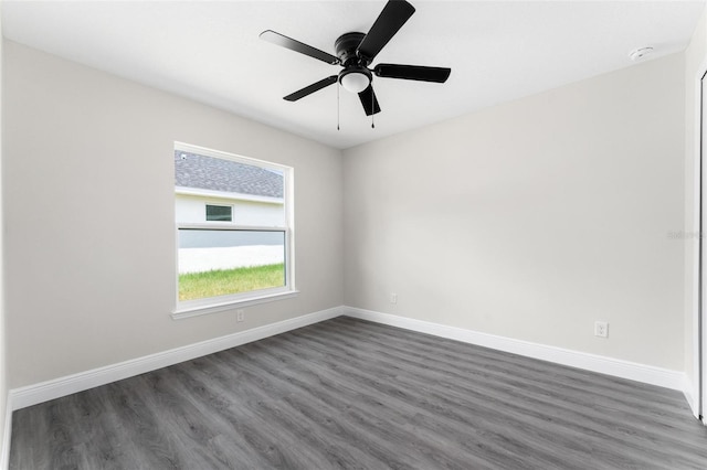 spare room featuring ceiling fan and dark hardwood / wood-style flooring