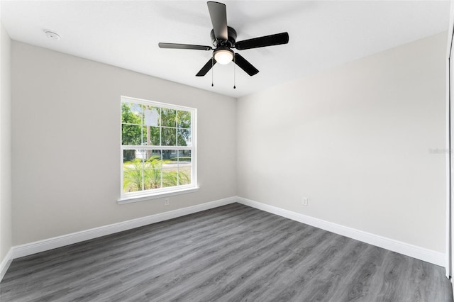 spare room with ceiling fan and dark wood-type flooring