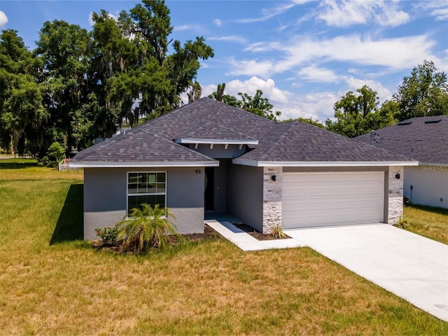 view of front of house featuring a front yard and a garage