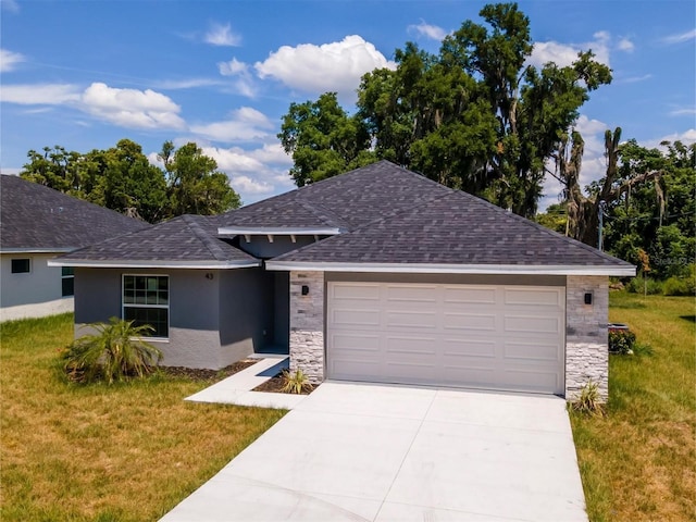 view of front of property with a front yard and a garage