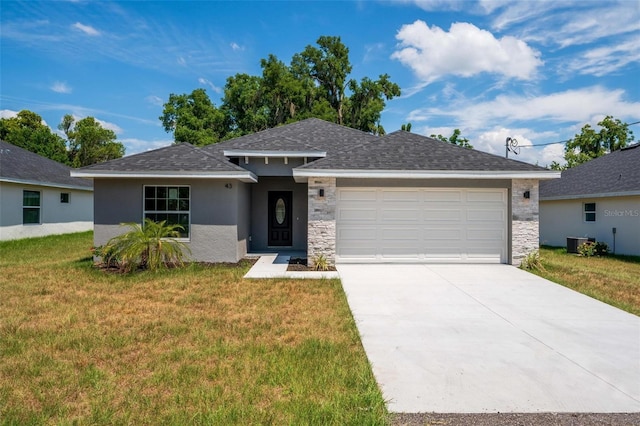 view of front of house with cooling unit, a front lawn, and a garage