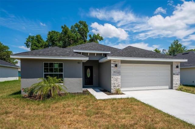 view of front of home with a front lawn and a garage