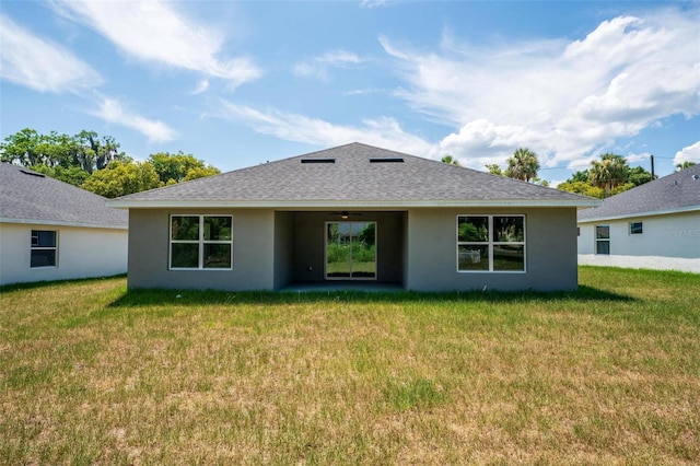 rear view of house with a lawn