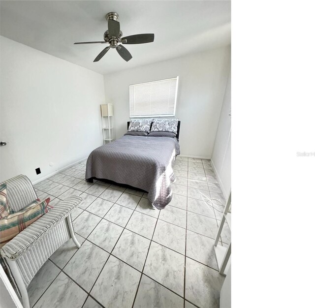 bedroom featuring light tile flooring and ceiling fan