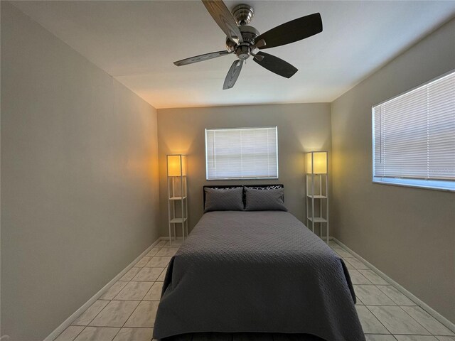 bedroom featuring ceiling fan and light tile floors