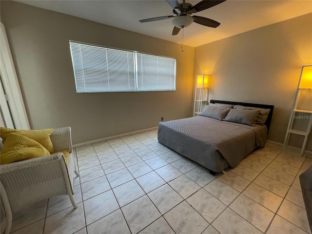 tiled bedroom featuring ceiling fan