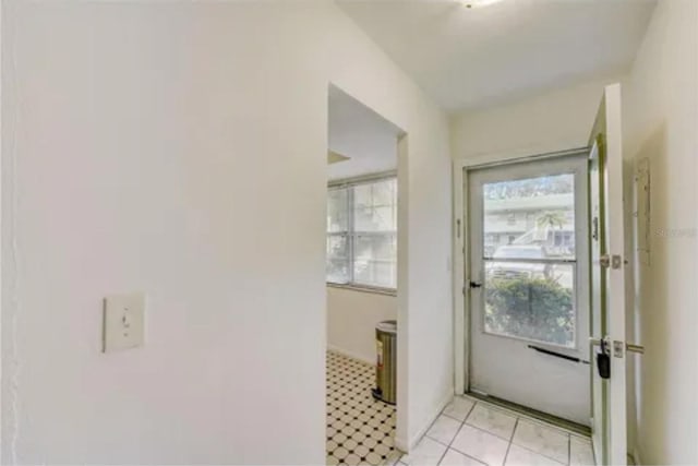 doorway to outside featuring light tile floors