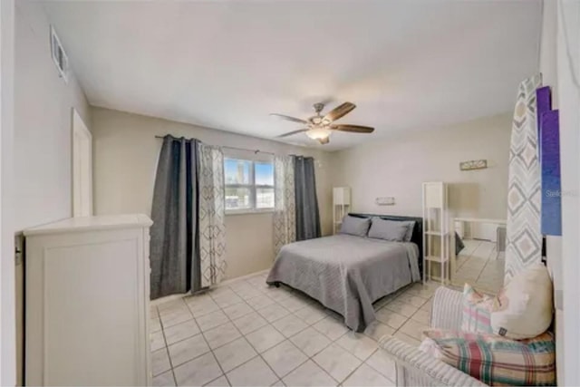 tiled bedroom featuring ceiling fan