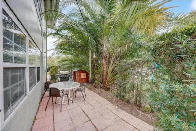 view of patio / terrace featuring an outbuilding and outdoor dining space