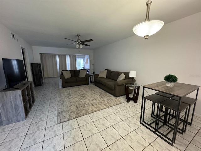 living room with light tile flooring and ceiling fan