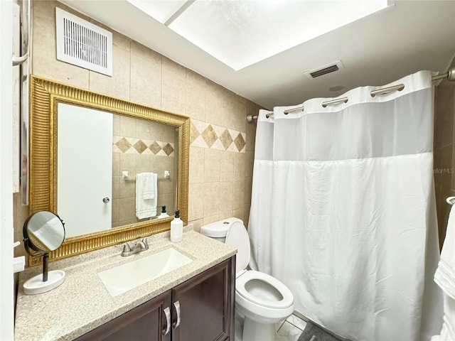 full bath featuring visible vents, curtained shower, tile walls, and vanity