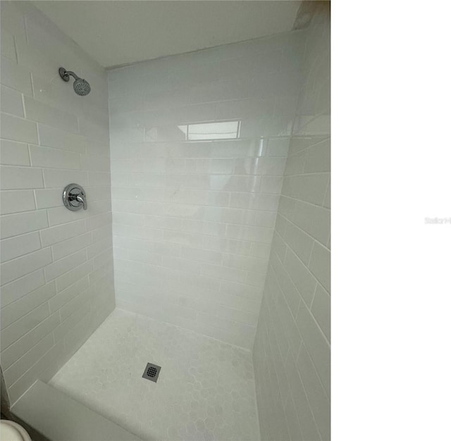 bathroom with tiled shower