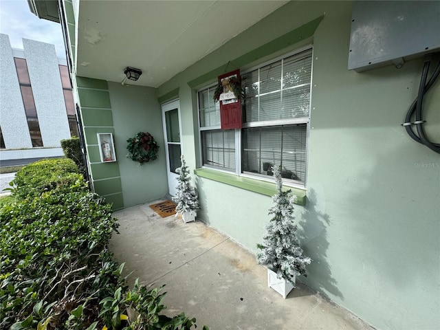 view of exterior entry with stucco siding