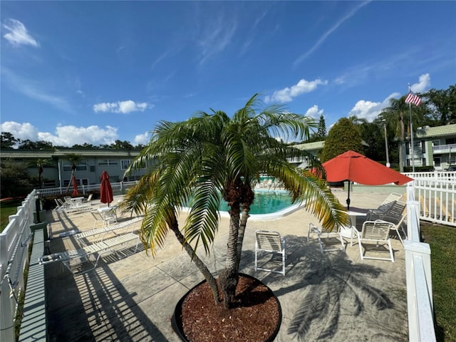 community pool featuring a patio and a fenced backyard