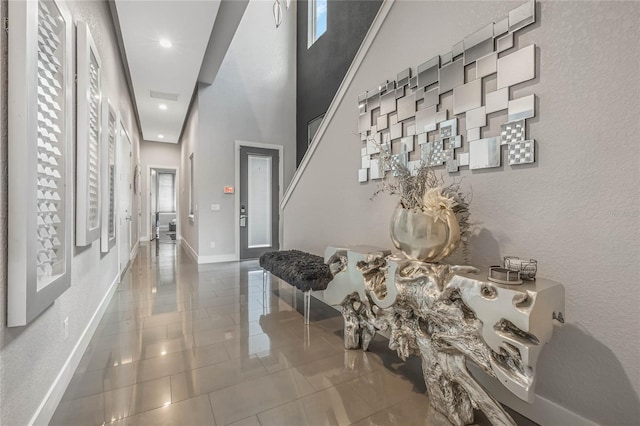 tiled entryway with a high ceiling