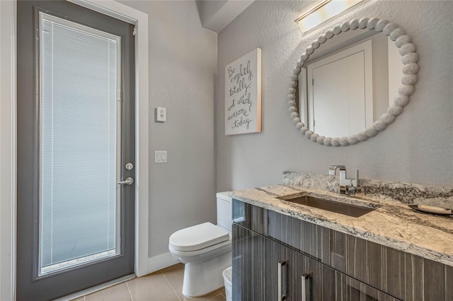 bathroom with tile patterned floors, vanity, and toilet