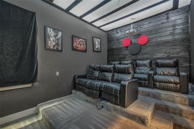 carpeted home theater featuring wooden walls