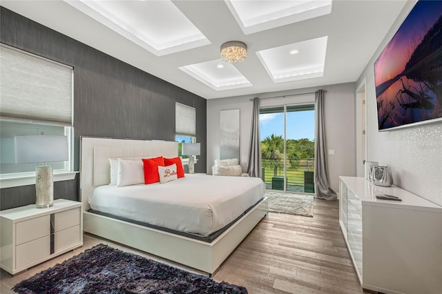 bedroom featuring light wood-type flooring and access to outside