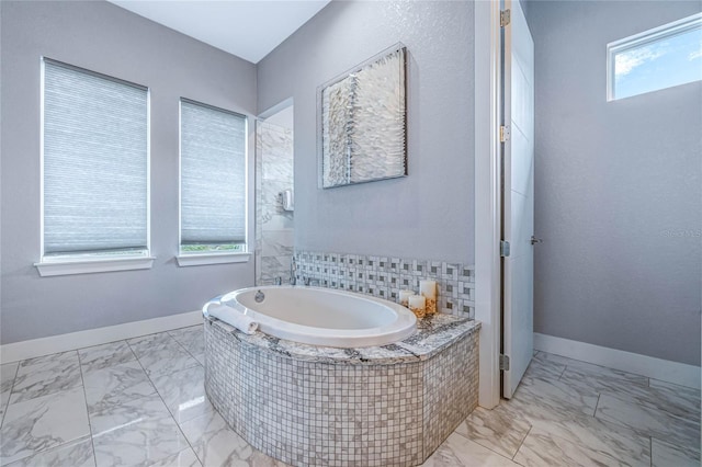 bathroom featuring tiled bath