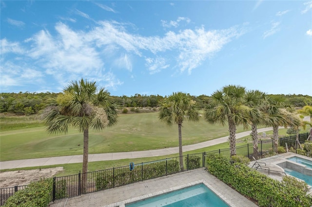 view of pool with a yard