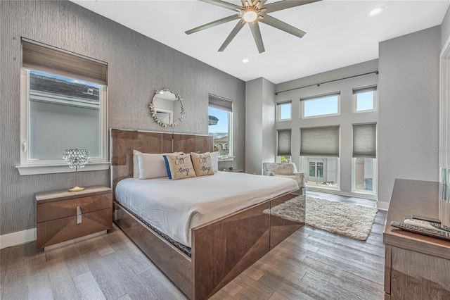 bedroom with hardwood / wood-style floors and ceiling fan