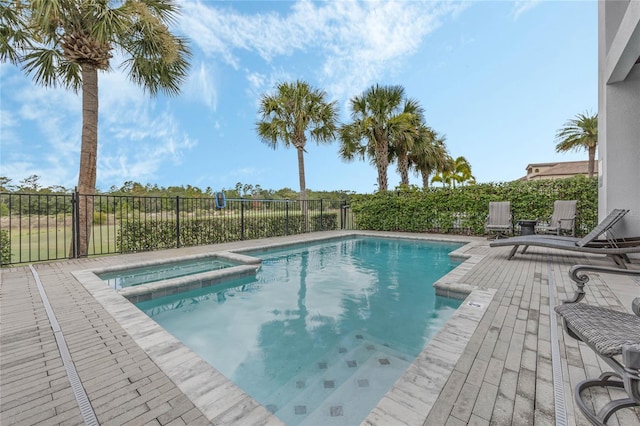 view of pool with an in ground hot tub and a patio