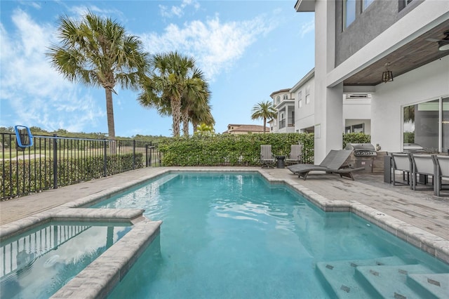 view of pool with area for grilling, a wall mounted AC, and a patio area