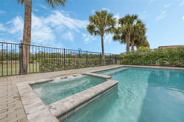 view of swimming pool featuring an in ground hot tub